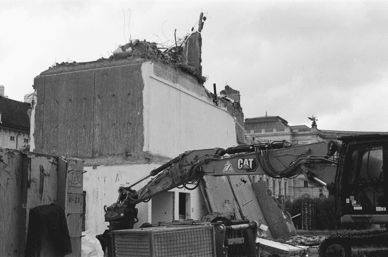 Partially demolished building, previously used as a working space for parliamentarians, at the so called "Heldenplatz" in Vienna, with a part of an excavator on the right, Black/White photography