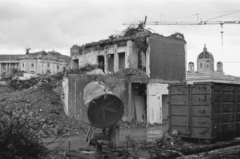 Partially demolished building, previously used as a working space for parliamentarians, at the so called "Heldenplatz" in Vienna, with a part of the art-history museum and a part of a crane in the back, Black/White photography